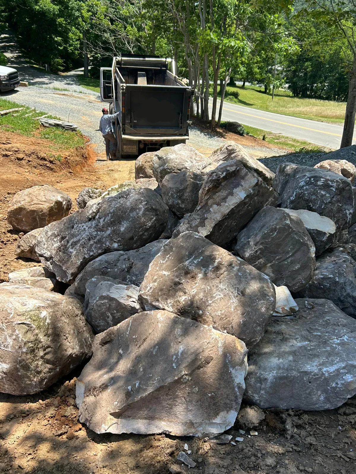 Large landscape boulders staged for rock and retaining work in Boone, NC