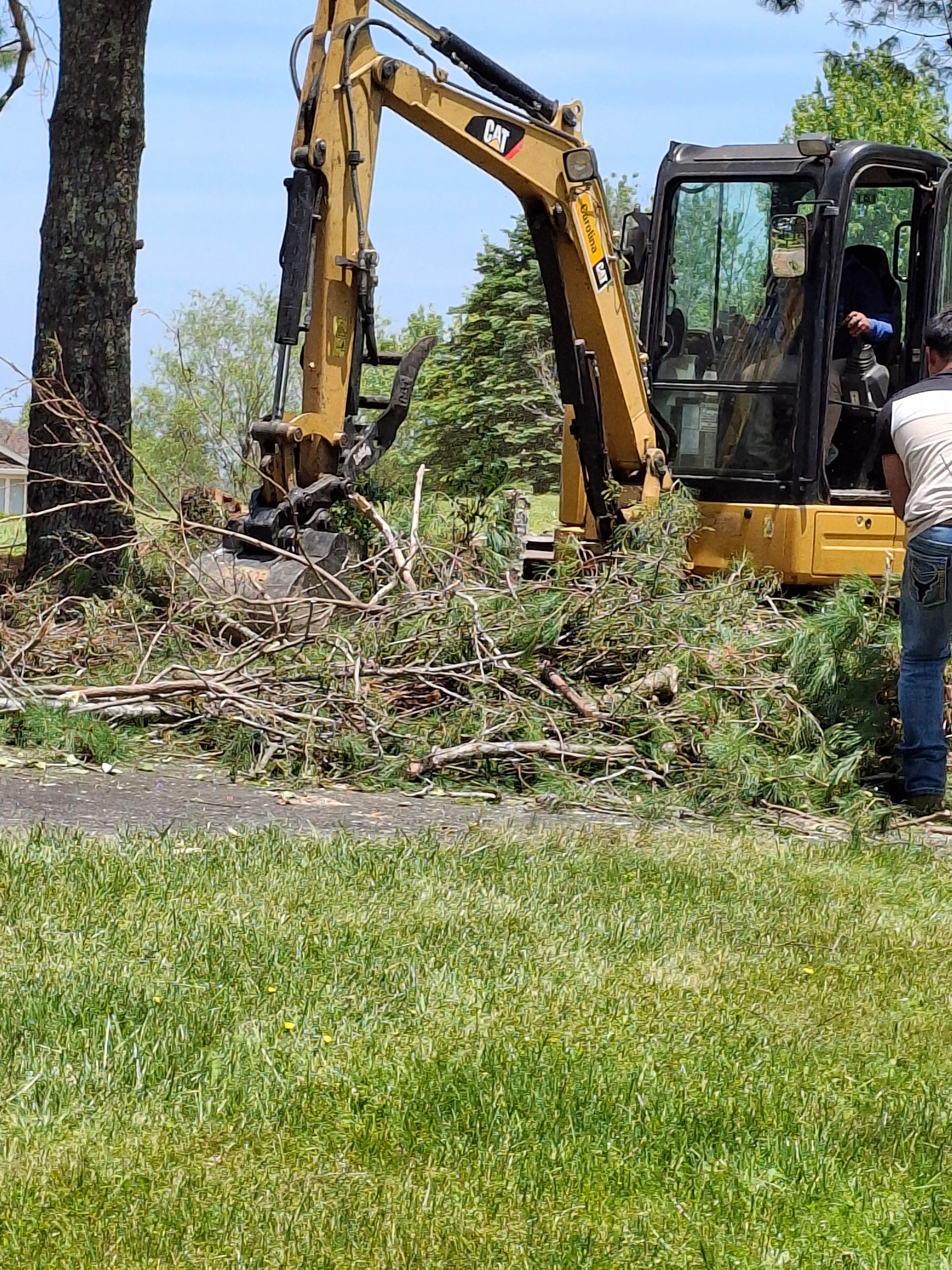 Excavator clearing brush and trees on a mountain lot in Watauga County, NC