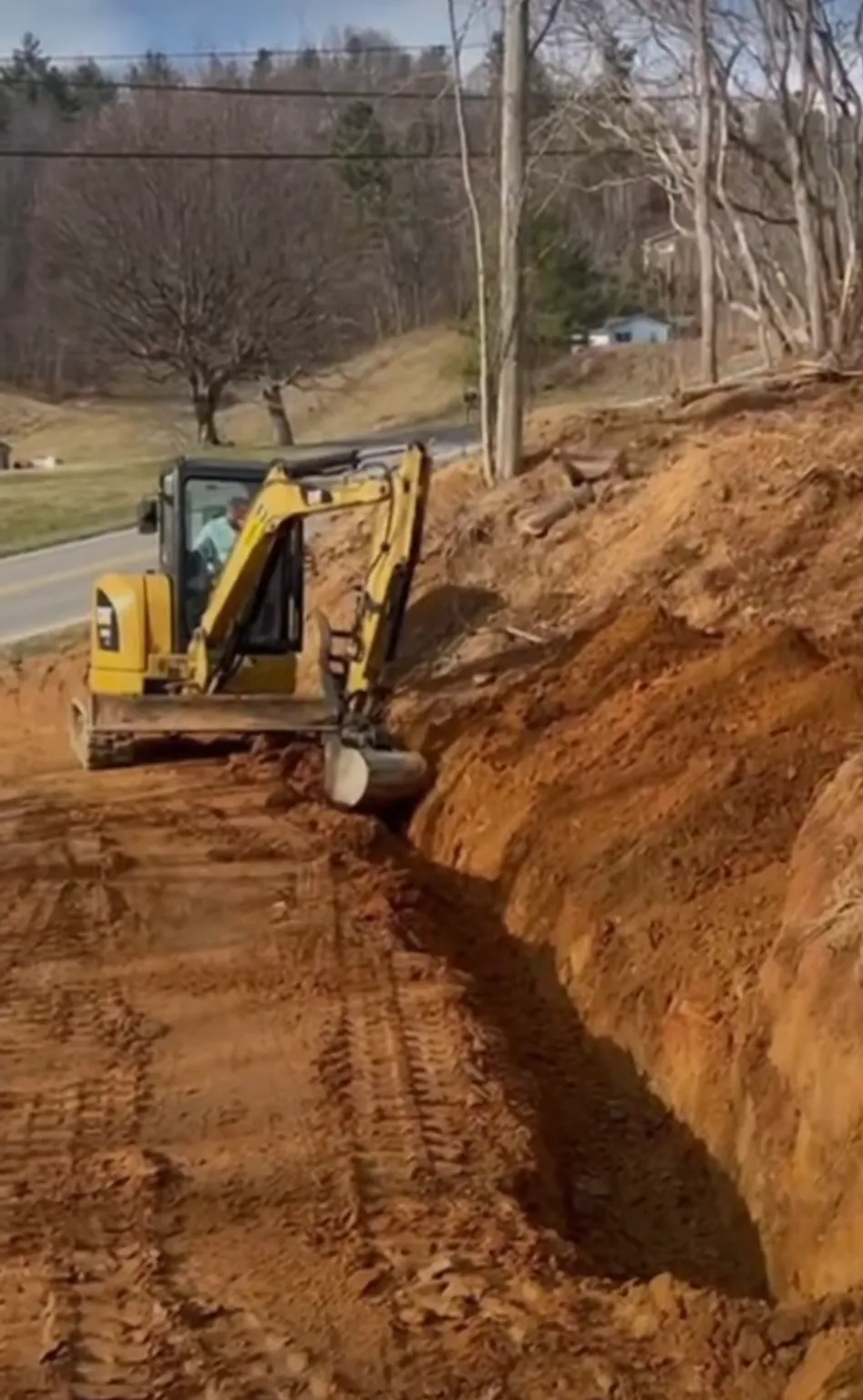 Excavation and grading a trench on a mountain property in Watauga County, NC